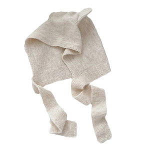 Minimalist oatmeal knit earflap beanie with long straps for winter warmth and protection