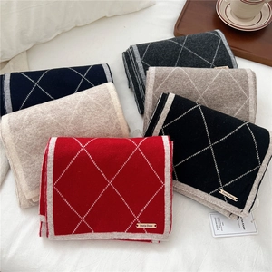 Diamond pattern knit scarf in red, black, beige, and grey with metallic logo detail