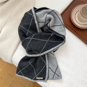 Close-up of diamond pattern knit wool scarf with premium metallic logo and soft texture