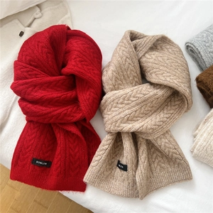Solid knit wool blend scarves in red and beige featuring classic cable knit texture