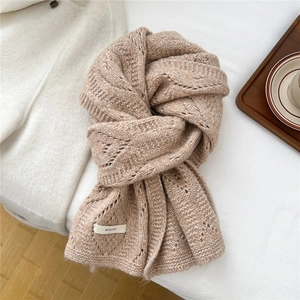 Detail of tan chunky knit wool blend scarf with hollow pattern and brand label