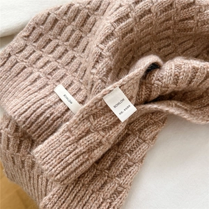 Detailed view of camel wool blend knit fabric with waffle texture and ribbed finish