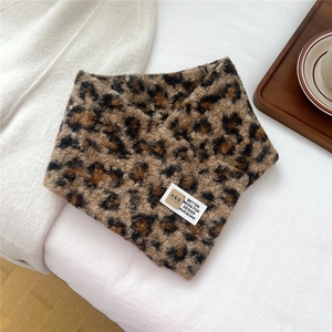 Close-up of leopard print plush neck warmer featuring a soft texture and brand label