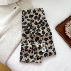 Close-up of leopard print plush scarf featuring thick faux fur texture and brand label