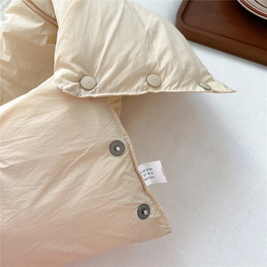 Detail of 100% polyester thermal neck warmer with metal snap button and care label