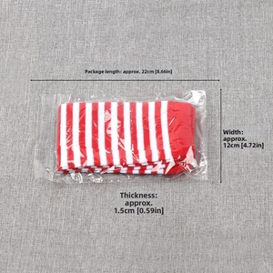 Detail of red and white striped fingerless long gloves in transparent plastic packaging