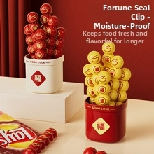 Detailed view of red and yellow food sealing clips with Fu character in a storage bucket