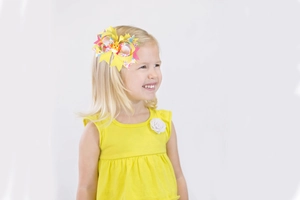Easter large yellow hair bow with chick centerpiece worn by a young girl in a yellow dress