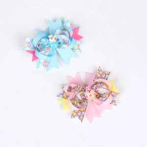 Detail of Easter hair clips with ribbon bows, colorful egg prints and cartoon bunnies