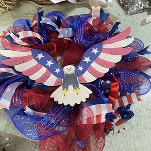 Detail of Fourth of July wreath featuring patriotic eagle and red blue metallic mesh