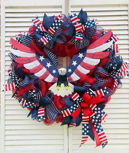 Macro detail of Patriotic Eagle Wreath with red white blue ribbons and glitter mesh
