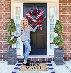 Detail of American flag wreath with eagle on a home front door for July 4th decor