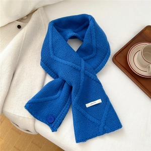 Detailed view of 100% wool knitted scarf with button detail in royal blue finish