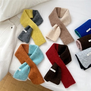 Knitted crisscross scarf in colorful block patterns with soft wool texture for winter warmth