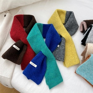 Knitted crisscross winter scarf with contrast color block design and brand label