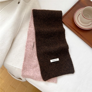 Close-up of pink and brown knit scarf showing soft texture and BOOM PLAN woven label