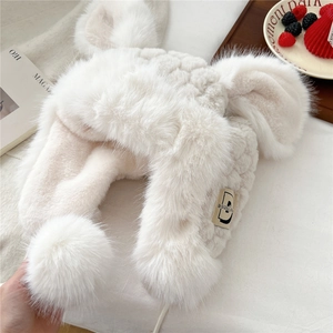 Detail of white plush trapper hat featuring long bunny ears and soft faux fur texture