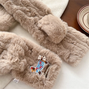 Close-up of plush faux fur scarf featuring a cute puppy embroidery and brand woven label