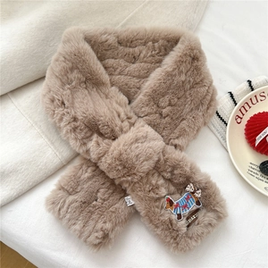 Close-up of soft plush scarf featuring detailed cartoon puppy embroidery and faux fur texture