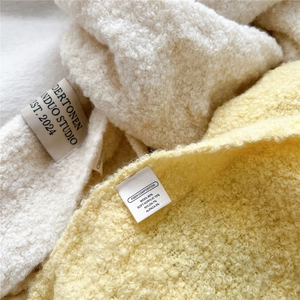 Macro detail of wool blend knit texture showing premium fiber composition labels