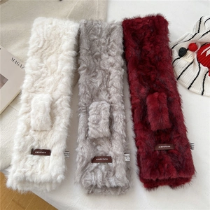 Detail of plush faux fur scarves showing soft texture and premium leather brand labels