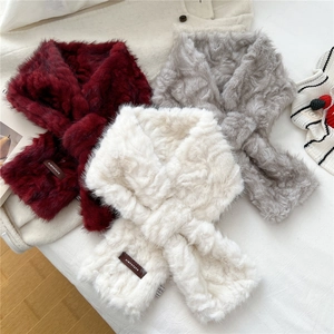 Plush faux fur cross scarves in burgundy, grey, and cream colors for winter warmth