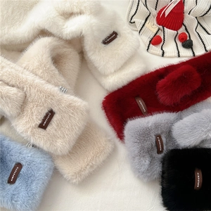 Detailed view of plush cross-through scarves in six colors with soft faux fur texture