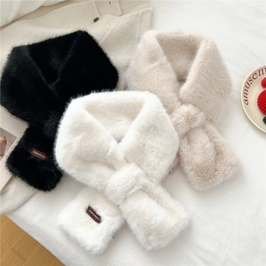 Detail of soft faux fur scarf with pull-through design and small leather brand logo