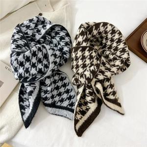 Classic houndstooth knitted scarves in black-white and brown tones on white fabric