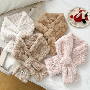Detail of plush faux fur scarves with wave texture and woven labels in four soft colors