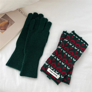 Close-up of thick knitted winter gloves with jacquard patterns and ribbed cuffs