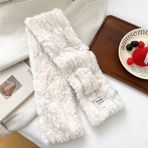 Detail of soft cream faux fur scarf showing cross-over design and premium plush texture