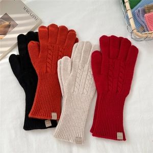Winter cable knit touch screen wool gloves for women in four colors on white fabric