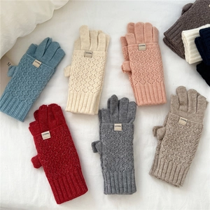 Macro detail of knit winter gloves with diamond texture and flip cover in various colors