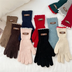 Women's warm knitted gloves in assorted colors with handmade leather tags and wavy trim