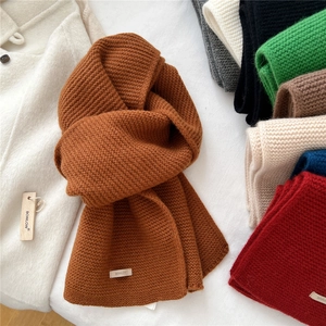 Solid color wool knit scarf in caramel brown with honeycomb texture and woven brand label