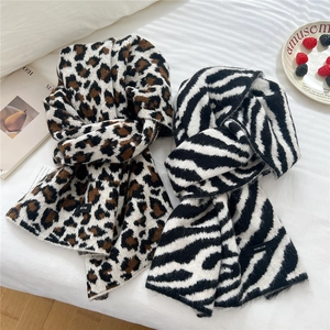 Wool blend leopard and zebra print knit scarves featuring a soft texture and brand label