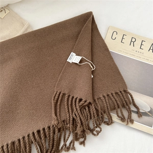 Detail of coffee brown 100% wool scarf with fringe and authentic material label