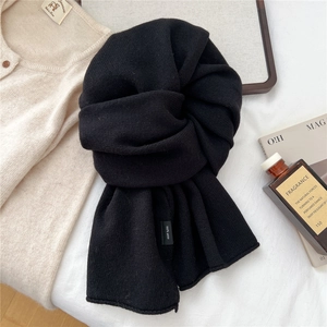 Detailed view of the 100% pure wool scarf texture with a focus on fine knitting craft