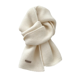 Solid color thick knit wool scarf in cream white with premium leather brand label