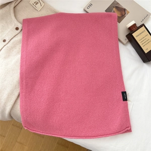 Detail of rose pink 100% wool knitted scarf showing soft texture and rolled edges