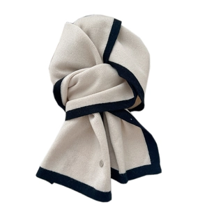 Dual-tone knit wool scarf in cream and black with vertical rib texture and metal tag