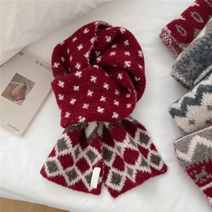 Knitted plaid scarf with red and white star patterns in a cozy winter style