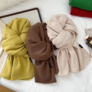Three premium knitted wool scarves in yellow, brown, and beige with 100% wool label