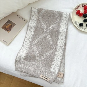 Detail of diamond pattern knit scarf made with 40% raccoon and 10% wool blend fabric