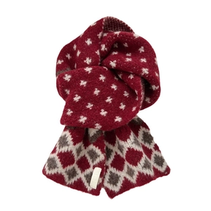 Deep red knit scarf with white star motifs and diamond patterns on white background