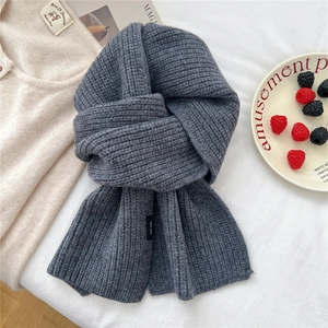 Close-up of dark grey 100% wool scarf featuring thick ribbed knit texture and soft fabric