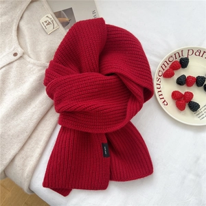 Close-up of red 100% wool knitted scarf showing thick texture and soft fiber details