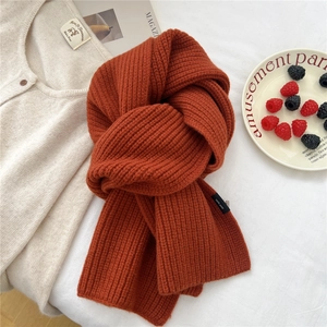 Macro detail of caramel thick rib-knit wool scarf with soft texture and warm winter vibe