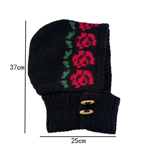 Detail of knitted balaclava with red rose pattern, wood buttons and 37x25cm dimensions